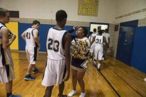 WPSD cheerleader Iris Hereford tries to cheer up one of the school's basketball players as he leaves the court after a game