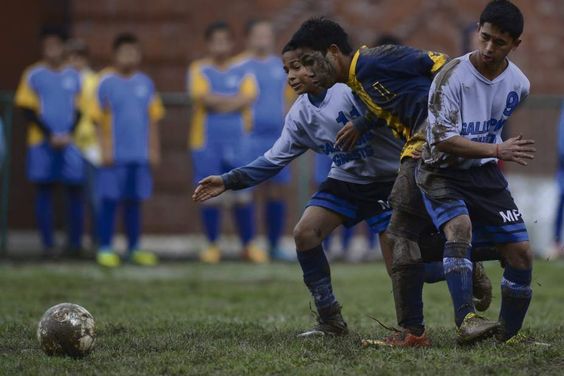 Seth Reeves, a senior soccer player for the Western Pennsylvania School for the Deaf chases the ball through two players from the Marie Phillip School during the third round of the Second Annual Eastern School for the Deaf Athletic Association soccer tournament.